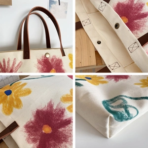 Close-up detail of floral canvas tote bag featuring leather handles and metal hardware