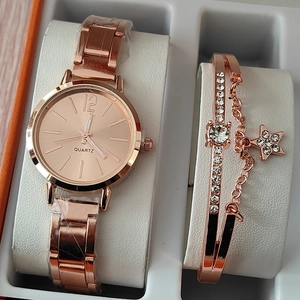 Detail of rose gold watch set with crystal-studded star pendant bracelet