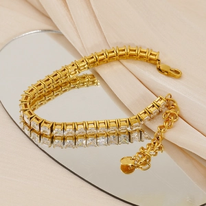 Gold plated stainless steel tennis bracelet with square cubic zirconia on beige silk