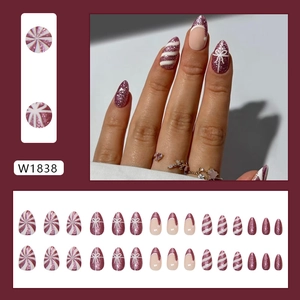 Purple glitter almond press-on nails with white stripes and festive bow art