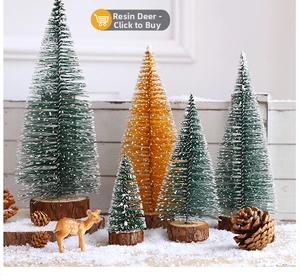 Miniature Christmas scene with sisal trees, resin deer and pine cones on artificial snow