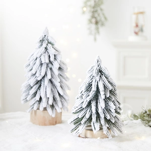Miniature flocked snowy Christmas trees with wooden bases for festive tabletop decor