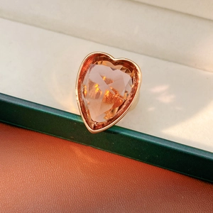 Macro detail of heart-cut champagne zircon ring with a wide rose gold plated band