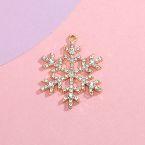 Detailed view of a gold snowflake pendant featuring sparkling inlaid white rhinestones