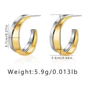 Detail view of irregular C-shape earrings showing gold and silver two-tone dimensions