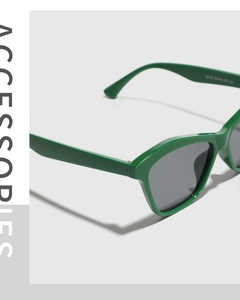 Detail view of bold green cat-eye sunglasses featuring size specs on the inner temple arm