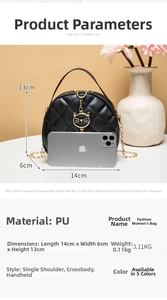 Macro view of black quilted circular bag with cat charm and phone for size reference