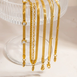 Detailed macro view of 18K gold plated stainless steel chain styles on glass rim