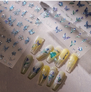 Macro shot of laser butterfly nail decals with 3D aurora effect and tulip motifs
