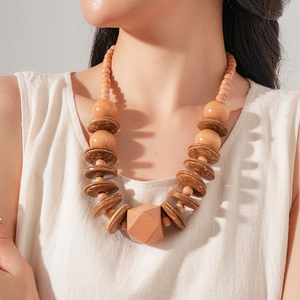 Detail of bohemian wooden bead necklace with coconut shell discs and geometric wood pendant