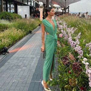 Detail of the glittering green swimsuit with waist cutouts and twist knot design