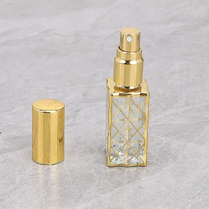 Detail of 12ml glass perfume bottle with diamond lattice and golden lily pattern