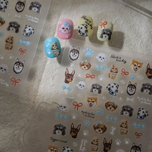 Macro detail of 5D embossed dog nail art stickers with cute husky and shiba inu designs