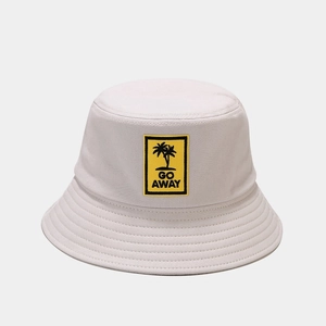 Detail of cotton bucket hat featuring Go Away text and palm tree embroidery on yellow patch