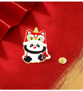 Macro detail of cartoon panda enamel brooch with lion dance hat and golden metal pin