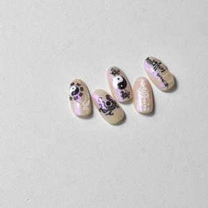 Detail of handmade press-on nails featuring Chinese yin yang and traditional motifs
