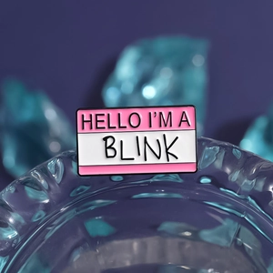 Pink and white rectangle enamel pin with Hello I'm a Blink text for bags and clothes