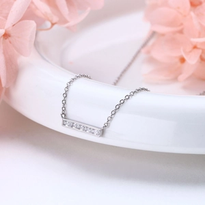 Elegant 925 sterling silver square bar necklace with sparkling zircon on a white vase