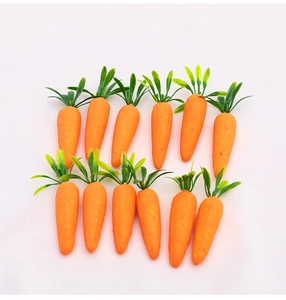 Row of twelve bright orange foam carrots with green leaves for Easter floral decoration