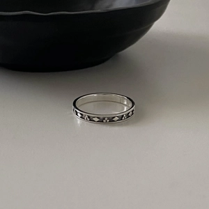 Vintage 925 sterling silver ring with geometric relief pattern on a minimalist background
