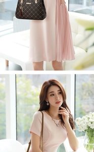 Close-up of pink pleated dress with short sleeves and elegant metallic accessory detail