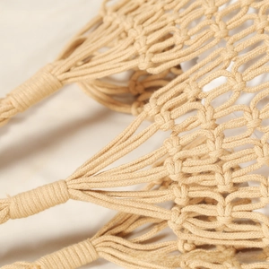Close-up of intricate hand-woven cotton rope mesh bag with rustic texture details