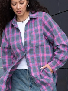 Close-up of pink and grey plaid shirt featuring a front pocket and button-down design