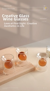 Detail view of double-walled glass shot cups with creative ball-shaped interior designs