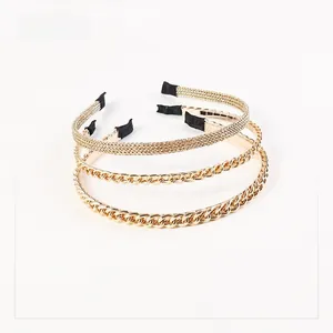 Detailed view of three gold alloy chain headbands with woven and twisted designs