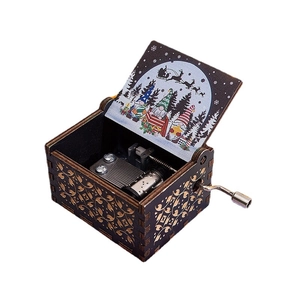 Hand-cranked wooden Christmas music box with Santa Claus illustration and gold vine carving