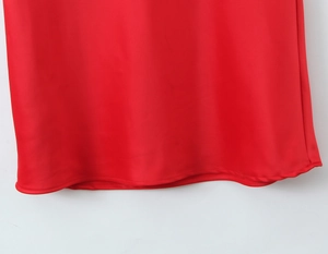 Detailed view of red satin mermaid dress hemline with high-quality neat stitching