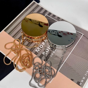 Top view of mini round acrylic evening bags in gold and silver with elegant metal chains