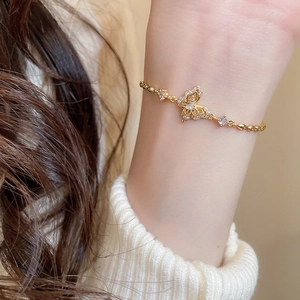 Close-up of 18k gold butterfly bracelet with zircons on a woman's wrist