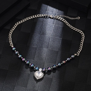 Silver chain necklace featuring dark peacock pearls and a large heart-shaped zircon pendant