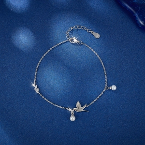 S925 sterling silver bird bracelet with zircon and shell pearl on dark background