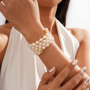 Detail of layered baroque pearl bracelet with gold beads and crystals on a model wrist