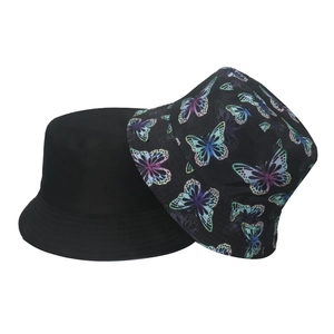 Reversible bucket hat with solid black side and colorful butterfly print on canvas