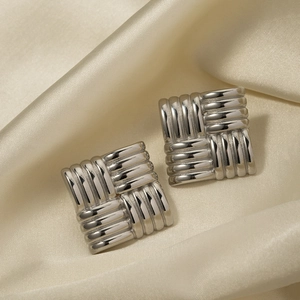 Textured square stud earrings in silver stainless steel on silk background