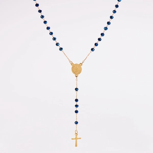 Detailed macro view of blue faceted beads and golden crucifix on vintage rosary necklace
