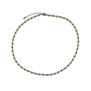 Detailed shot of two-tone gold and silver beaded necklace with adjustable lobster clasp
