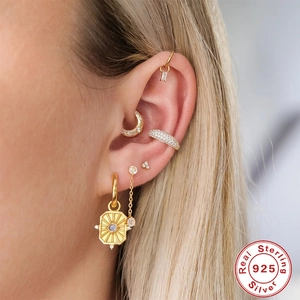Set of gold S925 sterling silver geometric hoop earrings and ear cuffs on model