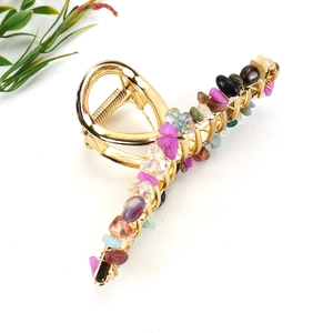 Detail of amethyst crystal hair claw clip with golden alloy wire-wrapped natural stones