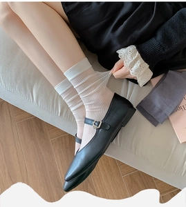Elastic ribbed pink crew socks for women shown with Mary Jane shoes on a cozy rug
