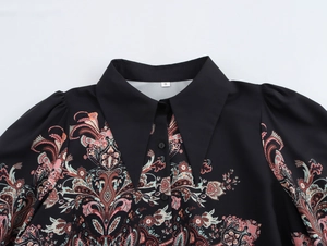 Detail of the vintage paisley pattern on the black ethnic blouse and size S tag
