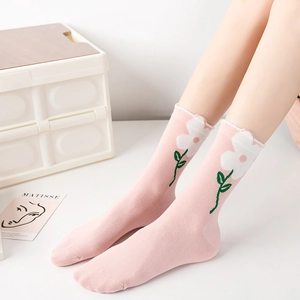 Pink mid-calf socks with white flowers, green stems and scalloped edges for women
