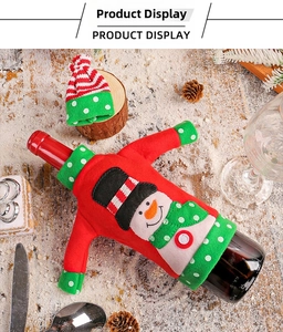 Detail of Christmas snowman wine bottle cover with miniature red sweater and striped hat