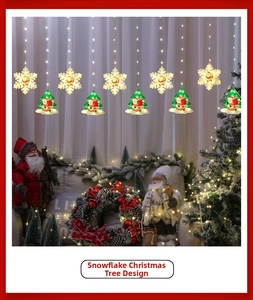 Detail of warm white LED curtain lights with glowing snowflake and Santa tree pendants