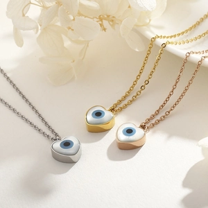 Detailed view of evil eye heart pendants in silver, gold, and rose gold plating