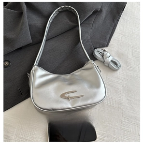 Silver crescent moon shoulder bag with metallic finish and metal logo accent and straps