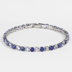 Detail of evil eye tennis bracelet with alternating blue beads and white zircon stones